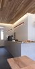 The monolithic tiled service counter viewed from one of the bench seat tables. Photo of Object Space (Phase Four Espresso) modern home