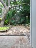 The continuity of the brick floor finish from outside to inside lends an exterior quality to the new living space, and a room-like quality to the terrace. Photo 3 of Villa Leichhardt modern home