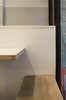 Seating immediately inside and outside the shopfront window diminishes the threshold between inside and outside. Photo 7 of Storefront for Cake and Architecture modern home