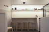 Floodlights create a general wash of background lighting, while concealed strip-lights highlight produce, products and serving dishes. Photo 4 of Storefront for Cake and Architecture modern home