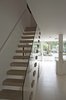 Modern home with Staircase, Wood Tread, and Glass Railing. The modern lower-ground floor connects to the rest of the house via an open-riser timber staircase with clear glass balustrade. Photo 2 of Soupçon Brut