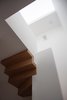 Modern home with Staircase. The staircase to the top floor is articulated as a sculptural, folded plane of timber. Photo 11 of Vertical Intersect