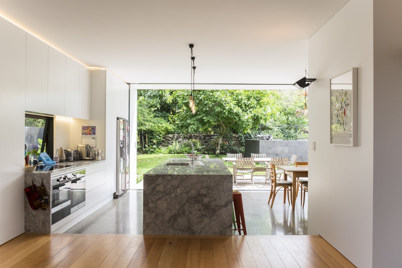 The new interiors are open-plan, but loosely divided into zones of use by rectilinear planes and volumes that accommodate the kitchen and other storage.