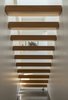 Modern home with Staircase, Wood Tread, and Wood Railing. The form of the top-lit, kauri-clad, open-riser staircase references the drawn appearance of a staircase, and recalls the Stack works of the American artist Donald Judd. Photo 7 of Case Study Villa