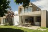 Modern home with Outdoor and Grass. Like the interior, the exterior massing is a composition of overlapping rectilinear volumes and planes, albeit at a larger scale. Photo 12 of Case Study Villa