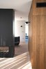 Modern home with Bedroom, Light Hardwood Floor, Wall Lighting, Wardrobe, and Storage. Referencing Donald Judd’s Specific Object artworks, the interior of the timber-clad bathroom volume is finished entirely in stone, and the frameless, glass-roofed shower recalls a James Turrell Skyspace. Photo 4 of Gallery Loft