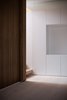 Modern home with Storage Room and Cabinet Storage Type. A high-level mirror—above the line of vision of a viewer—doubles the perceived size of the space, while also reflecting natural light from the open-rise staircase and the adjacent frameless glazing on the level above. Photo 8 of Gallery Loft