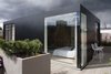 Modern home with Outdoor, Wood Fences, Wall, Hardscapes, Wood Patio, Porch, Deck, Decking Patio, Porch, Deck, Raised Planters, Rooftop, and Horizontal Fences, Wall. The new-build pavilion is clad in black panels, black-backed glass, and black warehouse-style windows. Photo 2 of Gallery Loft