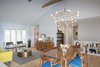 Modern home with Living Room, Storage, Sofa, Pendant Lighting, Console Tables, Chair, Coffee Tables, Shelves, Light Hardwood Floor, and Ceiling Lighting. Living/dining area Photo 4 of Gallery Residence