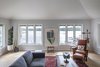 Modern home with Living Room, Sofa, End Tables, Light Hardwood Floor, Coffee Tables, and Chair. Sitting room with lake view. Photo 9 of Gallery Residence