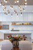 Modern home with Pendant Lighting, Light Hardwood Floor, and Recessed Lighting. Kitchen island and backsplash. Photo 14 of Gallery Residence