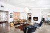 Modern home with Living Room, Sofa, Accent Lighting, Pendant Lighting, Concrete Floor, Gas Burning Fireplace, and Wood Burning Fireplace. bring the calm Photo 4 of - : - MidCentury Ranch in Dover Shores - : - for sale : 4 bed | 3 bath | 2032 sq' | large lot with a pool