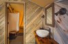 Modern home with Bath Room, Vessel Sink, Medium Hardwood Floor, Wood Counter, Wall Lighting, and Enclosed Shower. The Autonomous Tent runs on Treebones Resort's water supply. Solar panels power the LED lights, pumps, water filters, and a composting system. Photo 3 of Treebones Resort