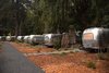 Modern home with Outdoor, Woodland, Walkways, Trees, and Shrubs. Dan Weber Architecture collaborated with Airstream USA to create the custom trailers at AutoCamp. The clear, non-tinted windows lend vintage charm and illuminate the grounds as evening sets in. Photo of AutoCamp Russian River