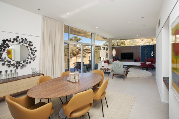 The home features an open floor plan with a combined living room, dining room, and kitchen. Clerestory windows punctuate the perimeter, allowing natural light to illuminate the space and forging a connection to the outside environment.