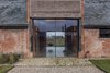 Modern home with Hallway. Two oversized glazed sliding doors welcome guests into Church Hill Barn. Photo 2 of Church Hill Barn