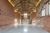 Modern home with Hallway and Concrete Floor. The renovation honors the grand, cathedral-like proportions of the original barn. In addition to the Photo 4 of Church Hill Barn