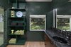 The master bathroom forges a connection to the outdoors through dark, forest green tile. Photo 8 of The Kelley Residence modern home