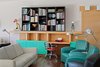 Custom built-in furniture is found throughout the home, such as this piece in the living room. The Tahiti lamp, an abstracted and geometric bird shape, was designed for the 1981 Memphis collection, and the Olivetti Valentine typewriter turned a piece of office equipment into a fashion accessory. Photo 5 of The Kelley Residence modern home