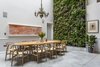 Modern home with Dining Room, Pendant Lighting, Table, Chair, and Concrete Floor. The living wall designed by Scotscape provides a refreshing backdrop to the dining area. Photo 7 of Clerkenwell Cooperage