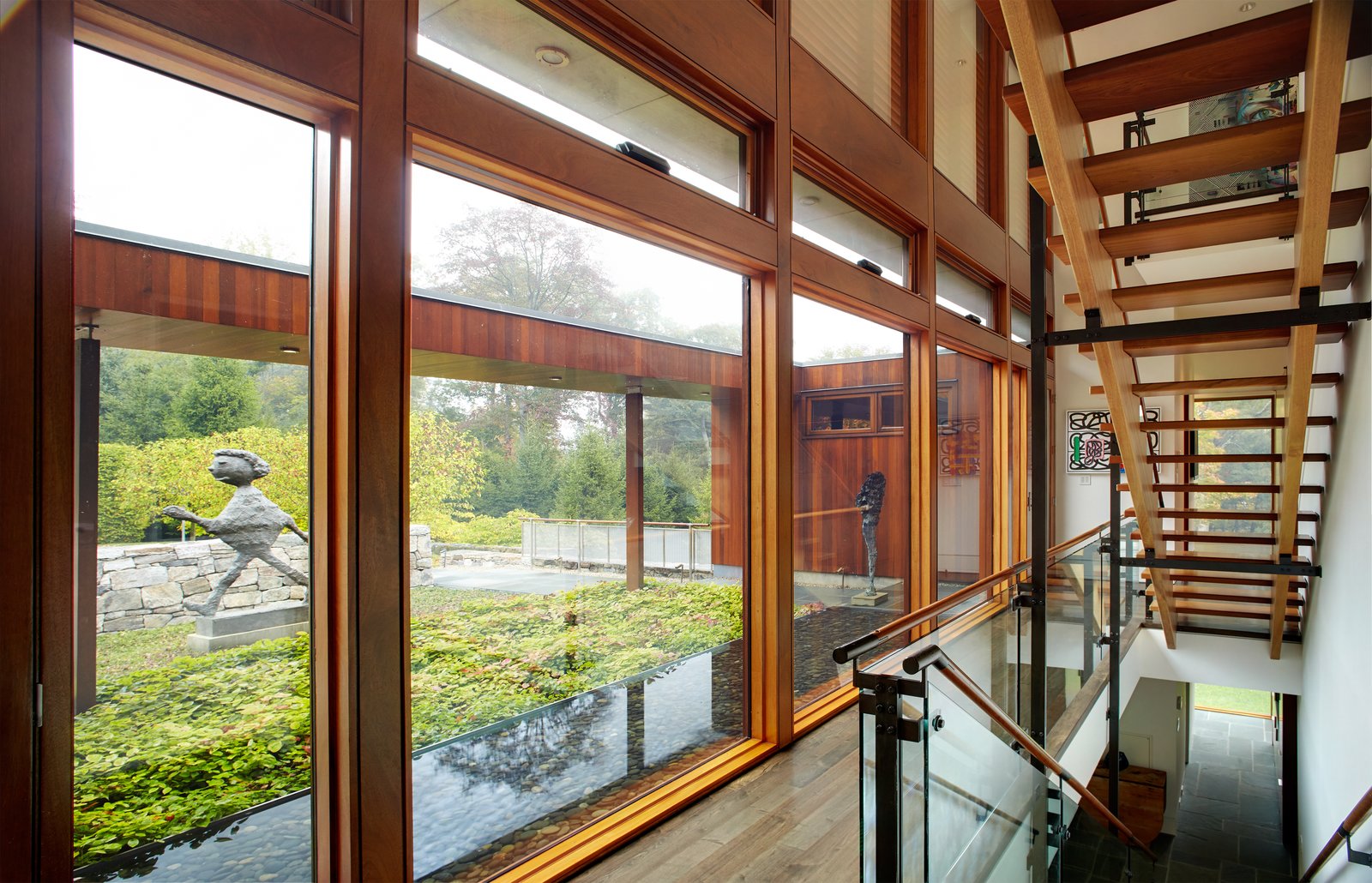 A two-story glass curtain wall allows for natural light and views to permeate the space and the open stairs.