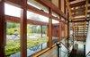 A two-story glass curtain wall allows for natural light and views to permeate the space and the open stairs. Photo 3 of The Brown Residence modern home