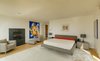 On the second floor are two ensuite bedrooms and a master suite with a private balcony, gas fireplace, and dressing room. The separate pool house, which has stayed true to its 1950 footprint, boasts two other bedrooms. Photo 7 of The Brown Residence modern home