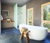 Modern home with Bath Room, Concrete Floor, Vessel Sink, Freestanding Tub, Soaking Tub, and Open Shower. A deep soaking tub offers relaxation and views of the surrounding foliage. Photo 8 of 534 Twin Bridges Road