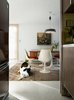 Modern home with Dining Room, Chair, Table, Pendant Lighting, and Terrazzo Floor. The homeowners love to host guests in the dining room, which features another set of Saarinen furniture. Banksy, a rescue lab and setter mix, takes a break from chasing toys up and down the hallways. Photo 8 of The Frost House
