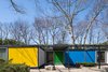 Modern home with Outdoor, Front Yard, and Small Patio, Porch, Deck. Built with a steel frame, the Frost House features panels of styrofoam between aluminum sheets for the exterior walls and styrofoam between plywood for the roof and floors. Bold, primary colors accentuate its geometric form. Photo 2 of The Frost House