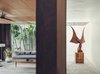 Modern home with Living Room, Floor Lighting, Bench, Coffee Tables, Concrete Floor, Rug Floor, Lamps, and Recessed Lighting. Garuda of Death Metal by Madsaki is a featured piece. Photo 8 of The Slow