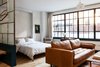 Modern home with Bedroom, Bed, Pendant Lighting, Chair, and Light Hardwood Floor. Each room features a curated collection of art and books. Photo 8 of Lokal Hotel