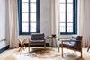 Modern home with Bedroom, Rug Floor, Light Hardwood Floor, and Chair. The sitting area, flooded with light from the ceiling-high windows. Photo 3 of Lokal Hotel