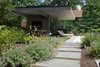 A view of the Free Float Pool House from the garden of lush plantings by Bayview Landscape Architecture. Photo 7 of Free Float Pool Cabana modern home