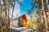 Modern home with Exterior, Metal Roof Material, Cabin Building Type, Gable RoofLine, House Building Type, and Wood Siding Material. Ohia forest setting Photo 2 of Kūono at Volcano