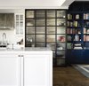 Ribbed glass in steel doors lets the light into the kitchen pantry. The Carrara marble of the benchtop is a timeless material. Photo 5 of Twin Peaks modern home