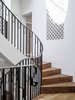 The stair rises from the entry to the bedroom level and winds up to the attic. The simple black steel balustrade design was embellished to satisfy the required feminine touch. Photo 15 of Twin Peaks modern home