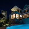 On the opposite side, the house tumbles down on the steep topography. A 1980s wing has been transformed with fluid eaves and new balconies. The pre-existing 1970s swimming pool contributes to the eclectic architectural landscape. Photo 19 of Twin Peaks modern home