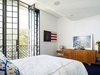 The tall French doors open inwards, European style, thanks to the ceiling rising in their proximity.
© Justin Alexander Photo 18 of Bougainvillea Row House modern home