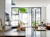 The lightwell over the living room on the left allows the morning sun to bounce down to the kitchen. Fine timber windows are designed to offer multiple uses for all seasons.
© Justin Alexander
Photo 15 of Bougainvillea Row House modern home