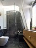 The master ensuite provides a brass shower under the stars and a toilet with a view of the clouds. The slate tiles can be used as blackboards.
© Justin Alexander
Photo 19 of Bougainvillea Row House modern home
