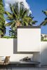 At the centre of the courtyard, the barbeque and fireplace is the spot to gather on a summer night to roast marshmallows and redesign the world. The concrete seat can be used as a sun lounge or a bench.
© Justin Alexander Photo 7 of Bougainvillea Row House modern home