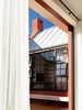 An off-form concrete bench terminates the long courtyard under the library window. Soon a canvas awning will cover the seat, and a table and chairs will invite the family and their guests to relax in the shade.
© Justin Alexander Photo 8 of Balancing Home modern home