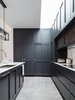 Two fridges and a pantry are hidden behind the panelled doors.
© Justin Alexander Photo 20 of Balancing Home modern home
