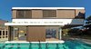 The first floor bedrooms cantilever towards the backyard, being larger than the ground floor living spaces. The two rectangular volumes are shifted, each with different wall constructions: very glazed and open downstairs, and closed upstairs. The bedrooms have two sliding shutters, manually controlled.
© Justin Alexander Photo 5 of The Pool House modern home
