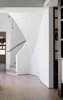 Linking the old house to the new is the spiral storage stair. The joinery to the right is a wine store.
© Justin Alexander
Photo 14 of The Pool House modern home