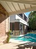 Appearing as a floating houseboat, the two story new building is surrounded by water. The verandah/carport is also new but detailed with traditional exposed rafters and ceiling lining boards, to complete the original verandah.
© Justin Alexander Photo 2 of The Pool House modern home