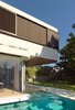 Glass Mosaic tiles give a natural shimmer to the water, similar to a pebble lined freshwater lagoon. Reflections on the soffits and ceilings provide unique light effects.
© Justin Alexander
Photo 6 of The Pool House modern home