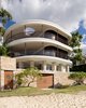 A copper rimmed hole was cut into the flat roof to bring light and air to a deep terrace. The landscaper delivered, by crane, three frangipani trees to soften the sea wall. Brass boat portholes are cut into the gate and the boathouse doors.
© Justin Alexander Photo 2 of Harbour Front-Row Seat modern home