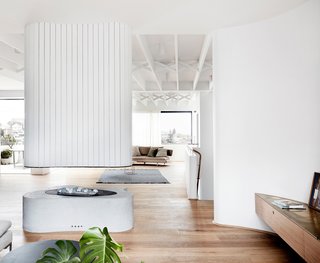 The crisp white walls contrast beautifully with the warm wooden floors throughout.